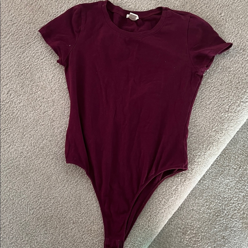 Women’s burgundy bodysuit. from a pet and smoke free home.